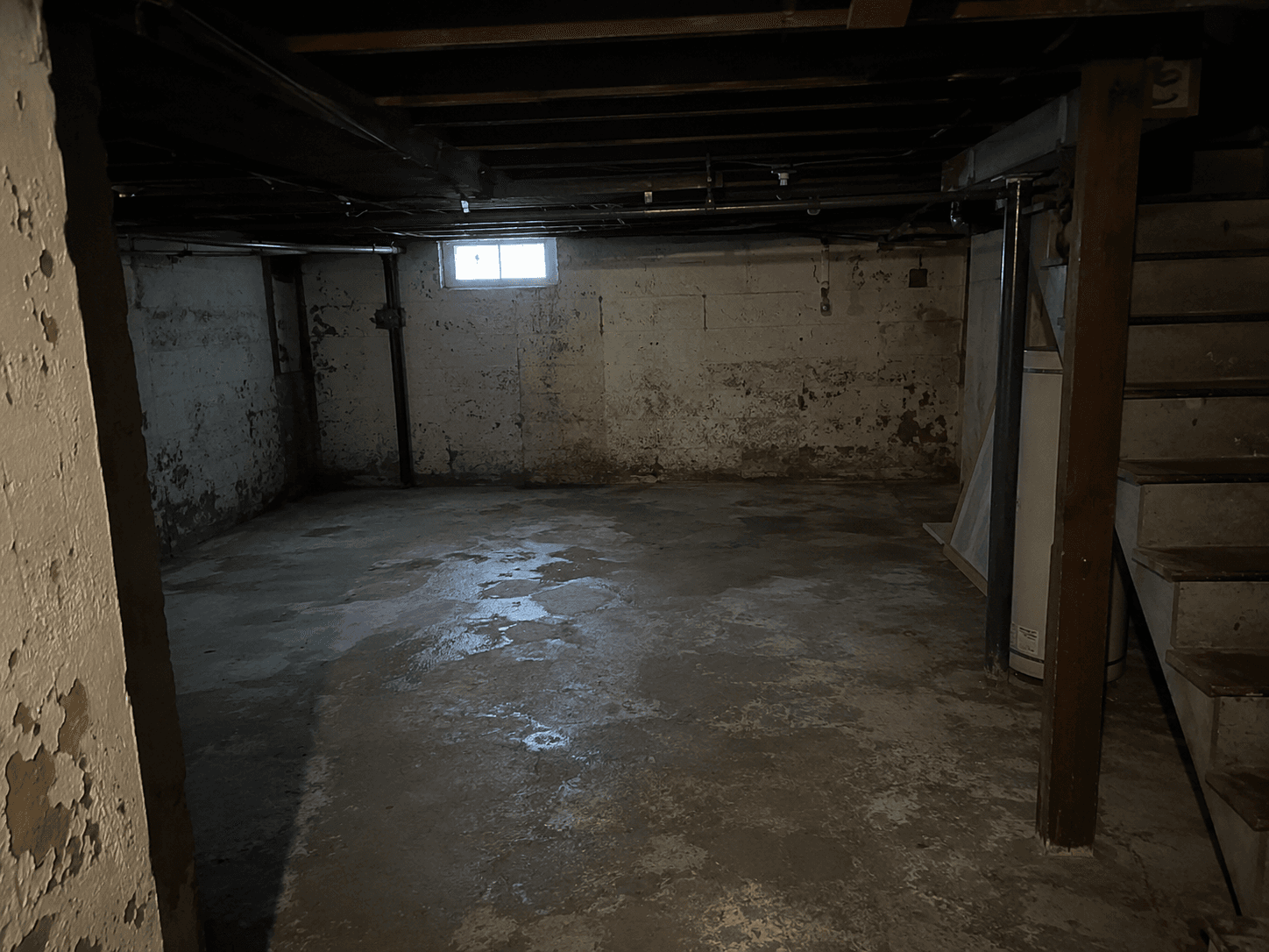 Empty unfinished basement before underpinning